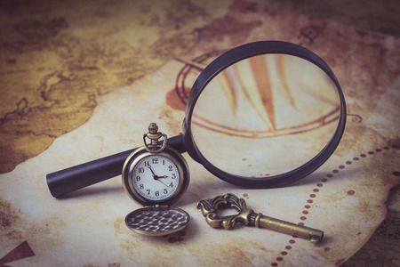 36850298 - old map with magnifying glass, pocket watch and old key