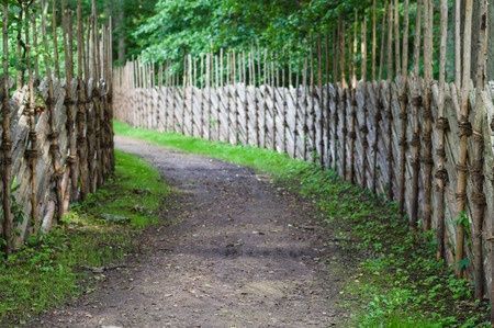 43487489 - defocused background of turning footpath between decorative wooden fences